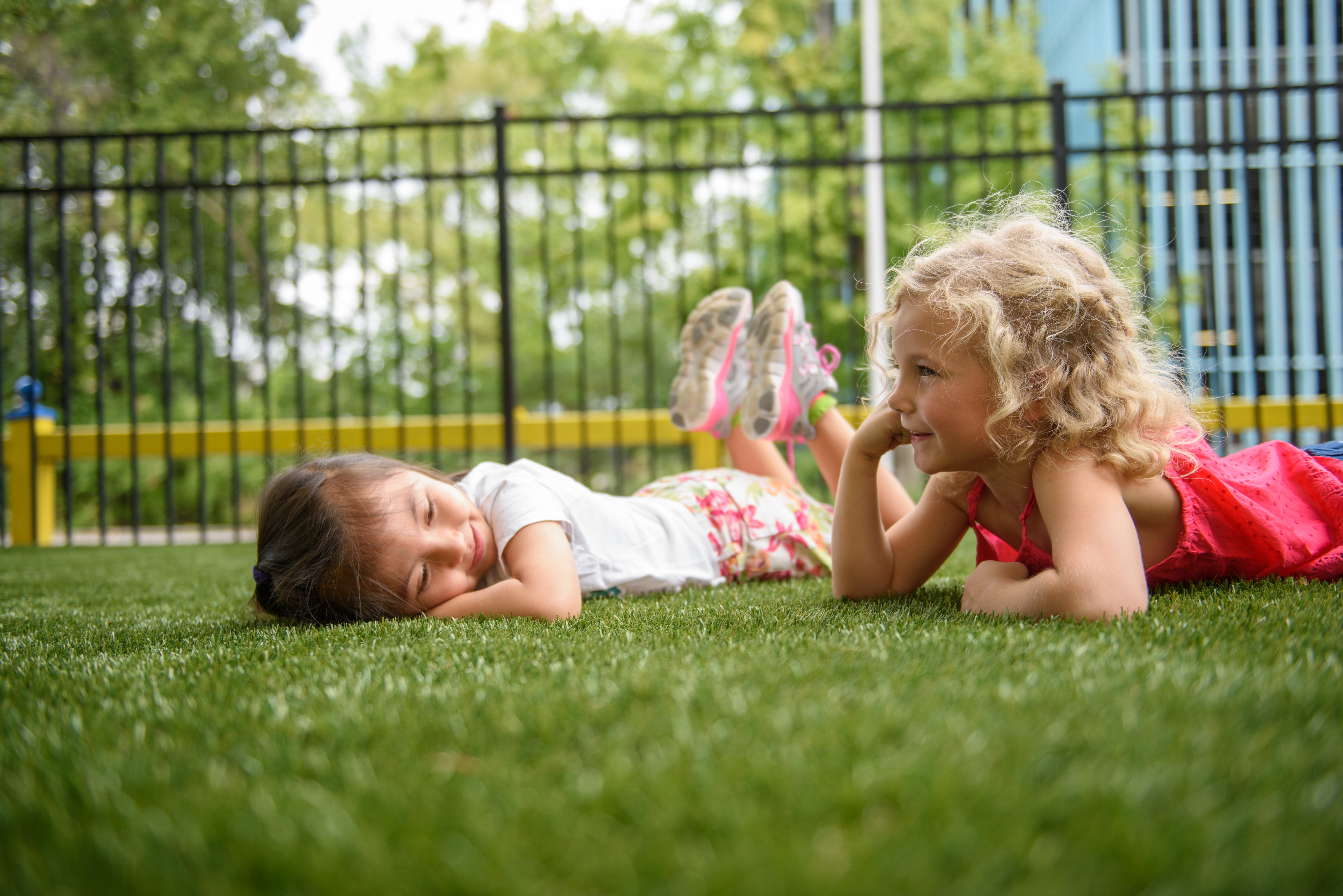 children laying on synthetic turf