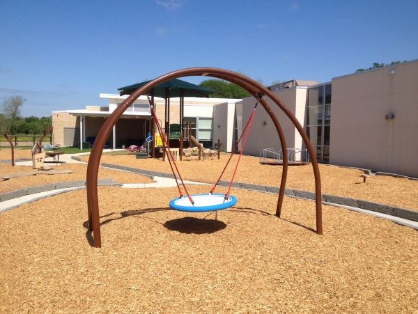 Swing with loose fill engineered wood fiber
