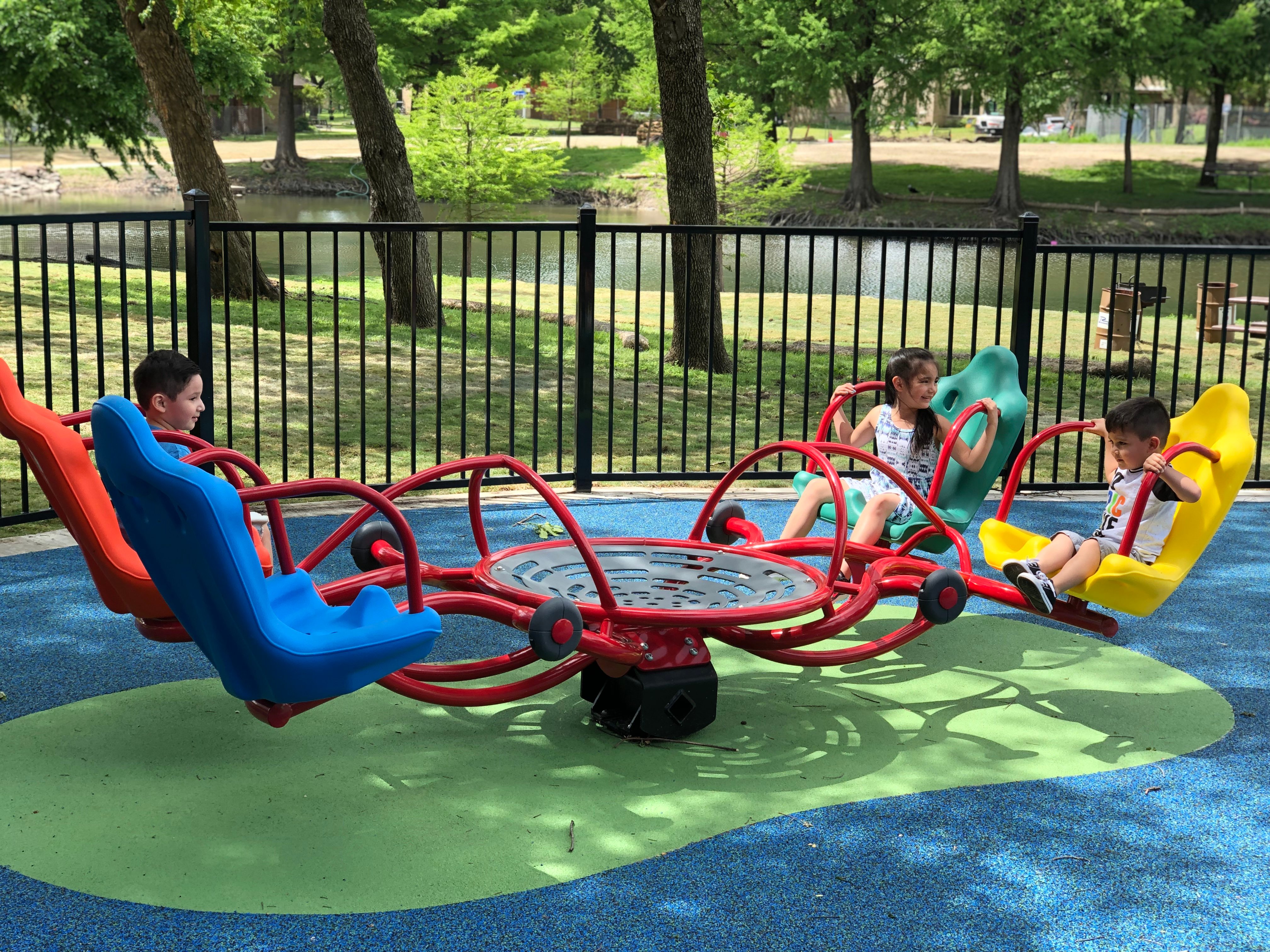 kids playing on playground equipment over poured-in-place playground surfacing