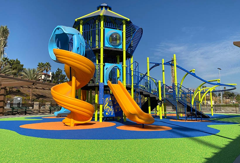 Colorful playground structure sitting poured in place surfacing.