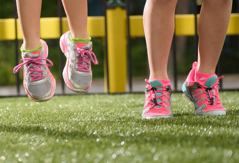 children jumping on synthetic turf