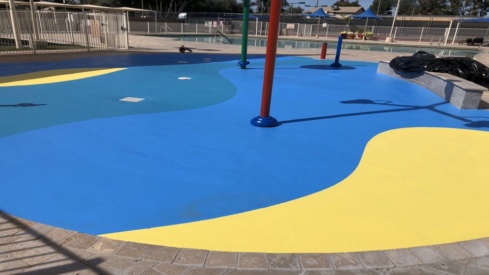 close up of blue and yellow splash pad surface